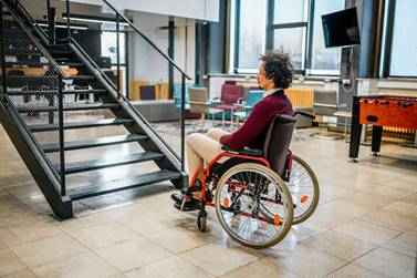 Man in wheelchair stuck at bottom of stairs - Employment Law